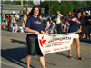 Women Carry the City of Wadsworth Cable and Internet Banner in Parade