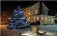 Wadsworth Historical Society at Night in the Snow With a Lit Up Christmas Tree
