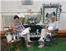Man and woman sit at Home Instead Senior Care booth.