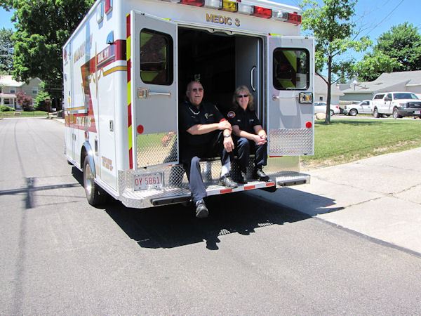 Paramedics Sit in Back of Ambulance